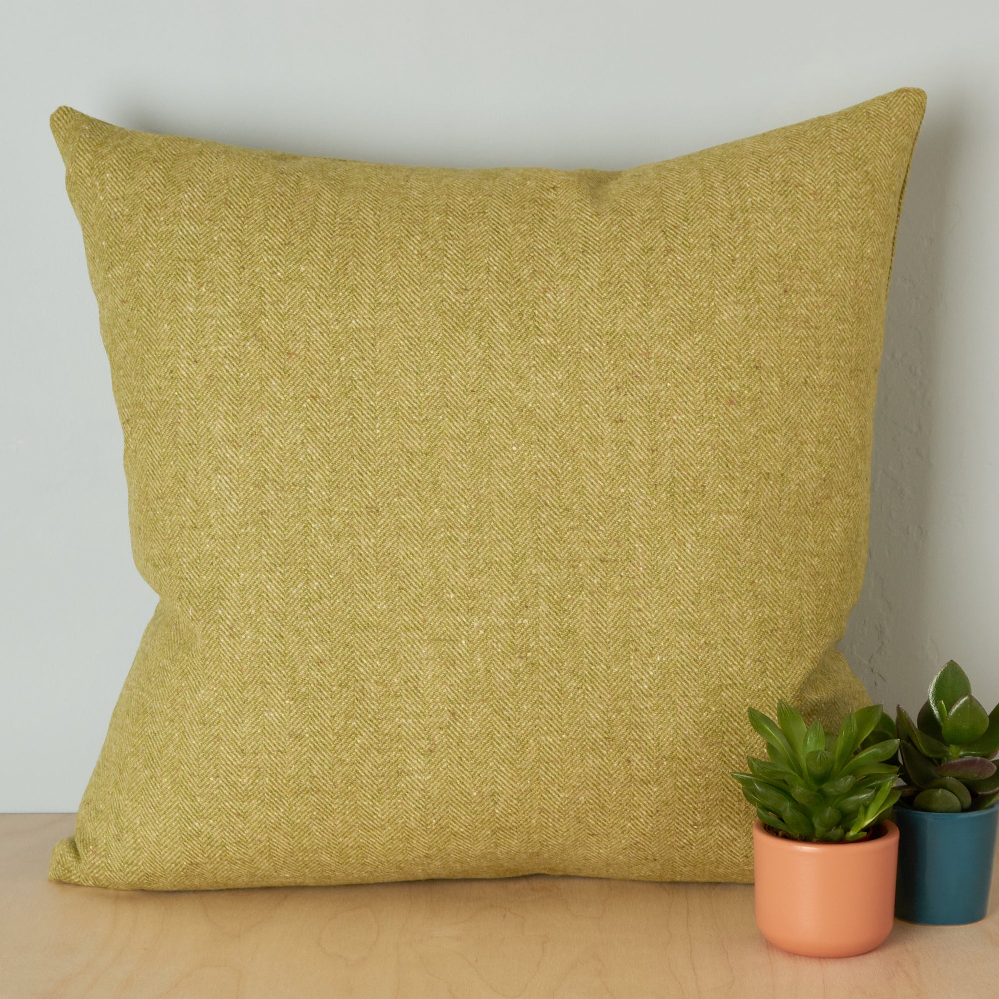 green wool cushion made in UK with Abraham Moon Wool